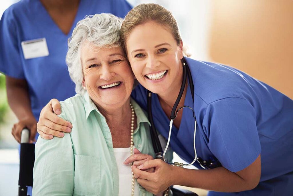 Family members review an assisted living floor plan with an older adult at a table.