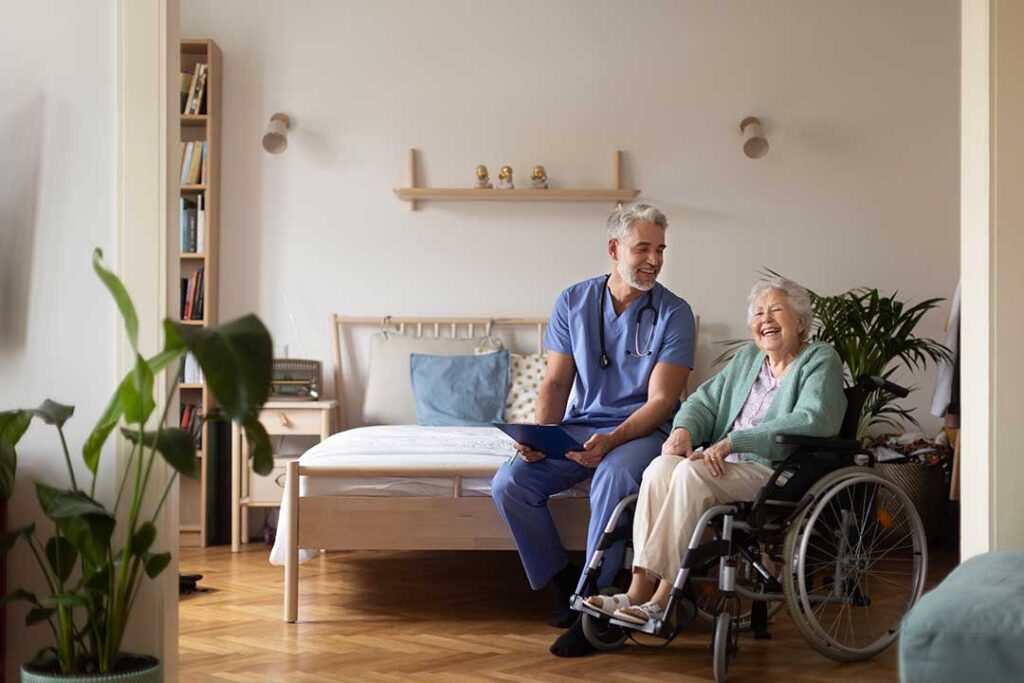 A caregiver reviews a personalized care plan with an older resident at a table.
